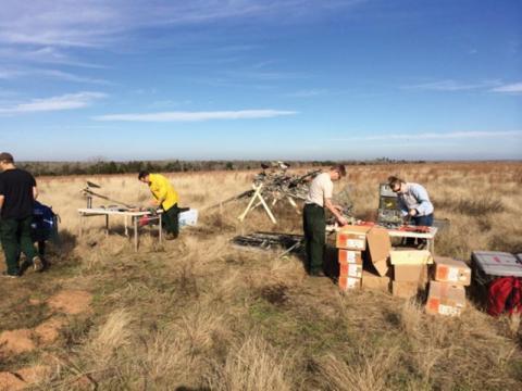 RMRS employees Mark Vosburg, Cyle Wold, and Emily Lincoln set up equipment for in situ monitoring of fire behavior.